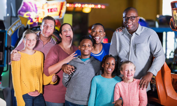 istock Two families having fun at an amusement arcade 1311318093