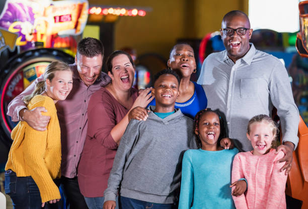 istock Two families having fun at an amusement arcade 1311318118