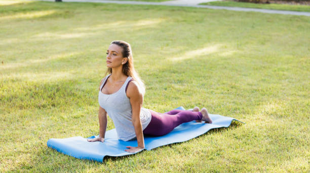istock Woman outdoors doing yoga, in cobra pose 1311318210