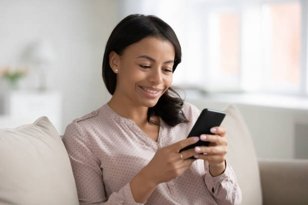 istock Happy biracial woman using smartphone relaxing at home 1311319785