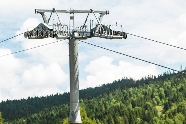 istock Cable car tower against blue sky and clouds 1311319855