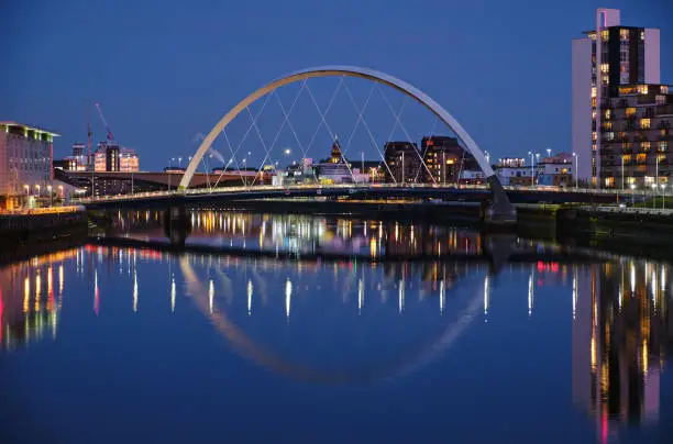 Night view of the Clyde Arc or Squinty Bridge from the East and river Clyde, Glasgow, Scotland
