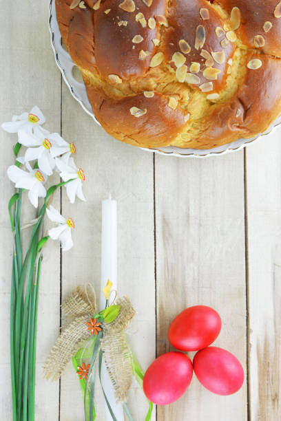 istock Easter concept with easter candle, red eggs, tsoureki and flowers 1311325609