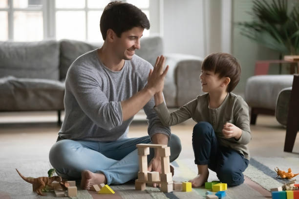 istock Close up happy father and little son giving high five 1311326670