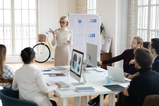 istock Confident female coach lead meeting in office 1311326725