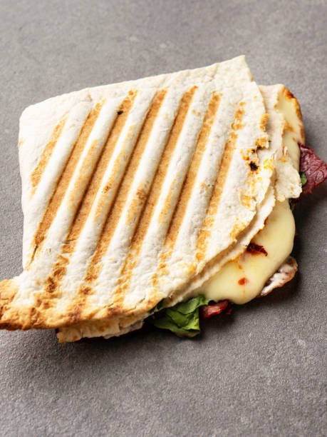 istock Thin bread toasted,  Toasted Sandwich, Grilled Cheese Sandwich, Crispy Grilled Sandwich with cheese, Flatbread pita filled with ham 1311326934