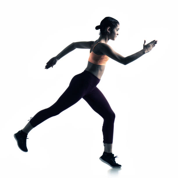 istock Athletic female running on white background 1311329589
