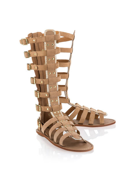 Pair of female beige leather boots isolated
