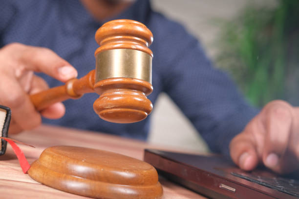 istock close up of person's hand striking the gavel. 1311330094
