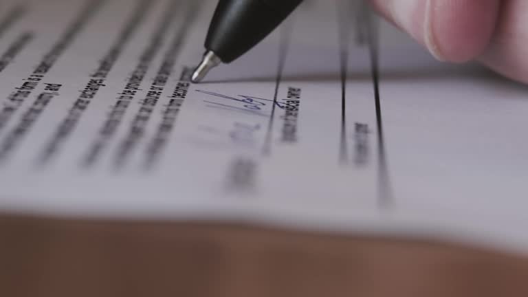 Signature on Contract by Pen in Hand. Write Business Agreement or Undersign Protocol of Convention. Close up. Move camera