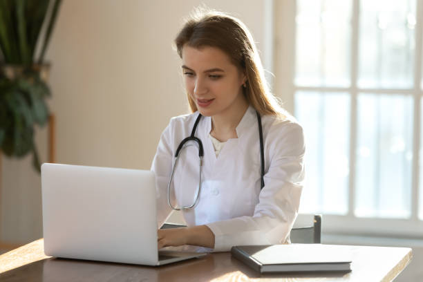 istock Young female doctor work on computer in private hospital 1311330569