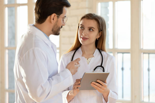 istock Diverse doctors use tablet in modern private hospital 1311330594
