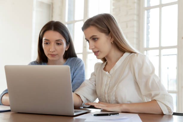 istock Female colleagues brainstorm working on laptop in office 1311330644
