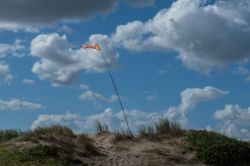 Green parachute from kite surfing in the blue sky with clouds. Space for text