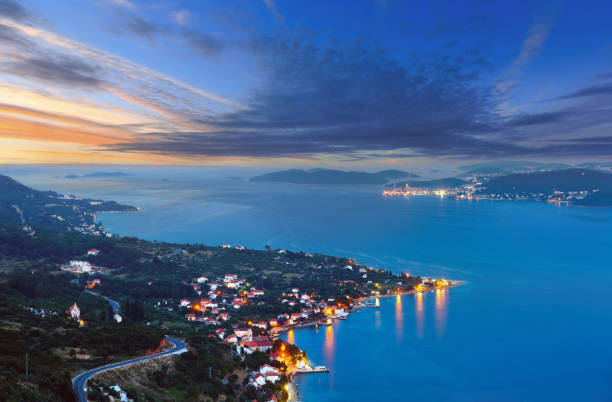 Night summer Croatian Peljesac peninsula (Viganj, Croatia) coastline, and Korcula village and island in far.