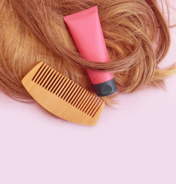 istock shampoo, wooden comb on a colored background 1311333614