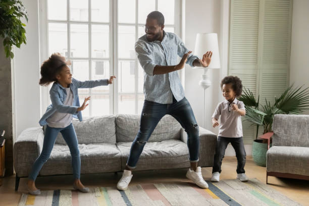 istock Happy black dad teaching kids to dance at home 1311335769