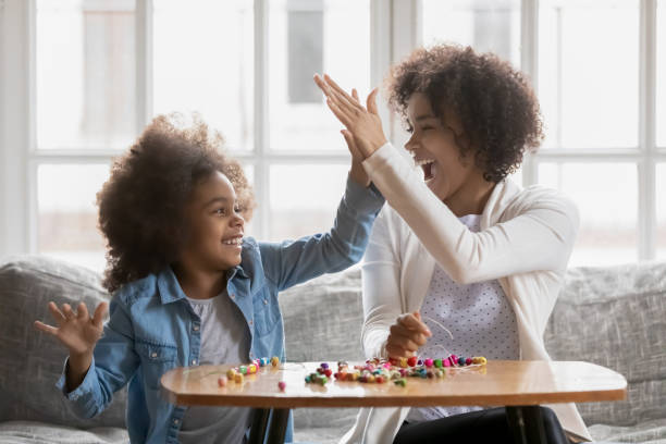 istock Proud mom giving high five to daughter 1311335776