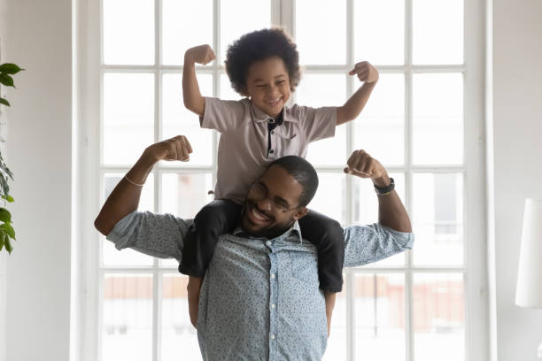 istock Happy funny kid riding on dads shoulders 1311335783
