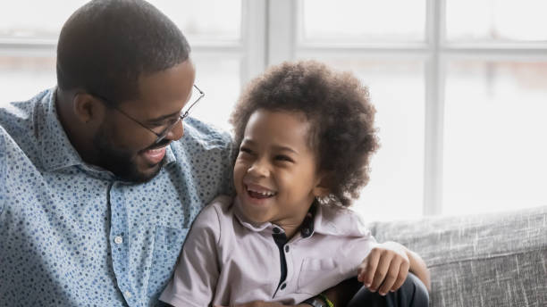 istock Happy cute Black boy enjoying leisure time with dad 1311335787