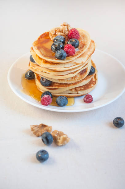 istock Delicious pancakes with blueberries and raspberries on a white plate. 1311336066