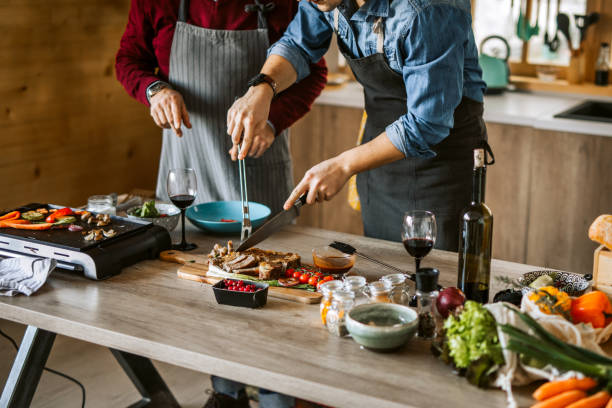 istock Father and son ejoying cooking dinner for friends together 1311336951
