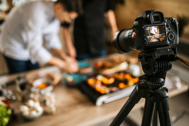 istock Father and son filming online cooking lessons 1311337150