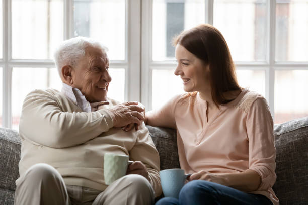 istock Elderly father enjoy conversation with daughter for cup of tea 1311337326