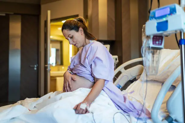 Young pregnant woman in the hospital ward and ready to delivery a baby.