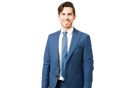 Attractive professional lawyer posing against a white background. Happy young businessman in a suit smiling and making eye contact