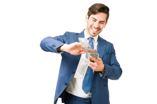 Businessman happy to spend a lot of money Excited young man throwing bills in the air and spending a lot of cash. Happy business coach giving financial and money advice spending money stock pictures, royalty-free photos & images