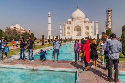 AGRA, INDIA - FEBRUARY 19, 2017: Tourists visit Taj Mahal complex in Agra, India