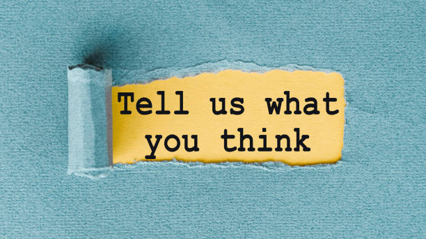 istock TELL US WHAT YOU THINK words written under ripped and torn paper. 1311347797