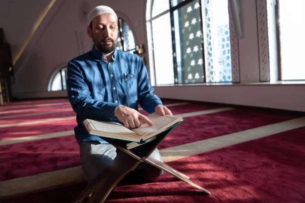 istock muslim man praying Allah alone inside the mosque and reading islamic holly book 1311348187