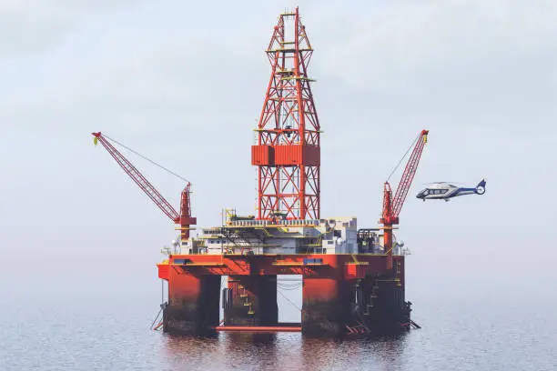 Helicopter landing on a helipad at offshore oil platform.