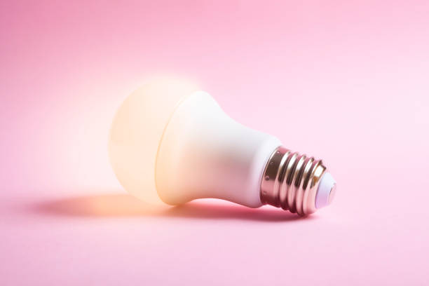 istock lit light bulb isolated on a pink background 1311349007