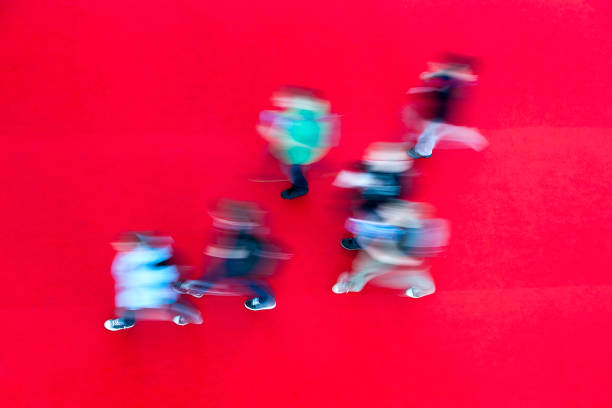 High angle view of blurred young people on red carped.