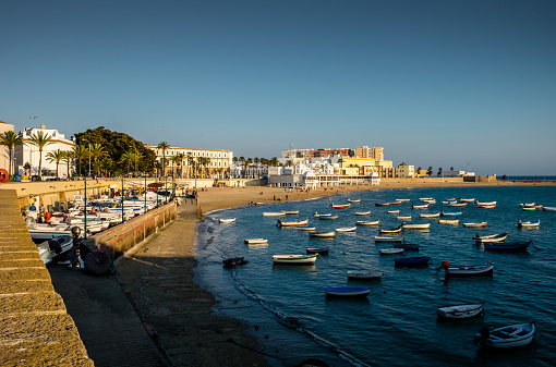 Sunset on the beach of La Caleta seen from the castle of Santa Catalina. Ficus, spa and University of Cádiz.