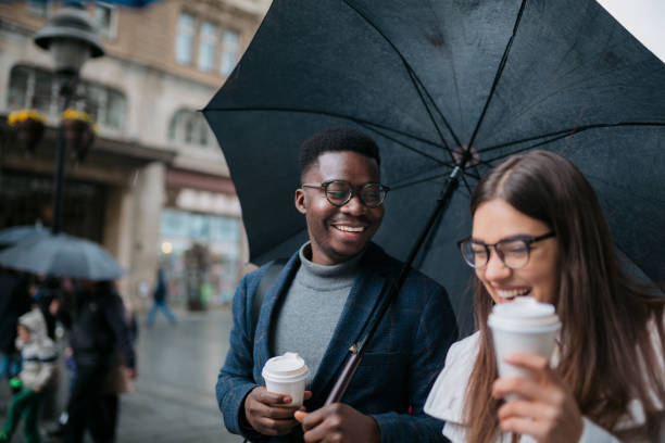 istock Happy diverse couple walking on a rainy day 1311351868