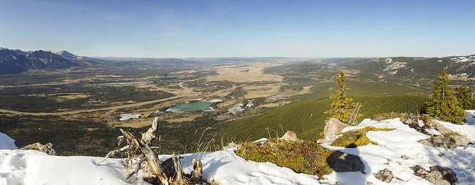 Panoramic Aerial Landscape View of Alberta Foothills and distant green Prairie Parkland on Horizon. Sunny Springtime Day Hiking in Canadian Rockies