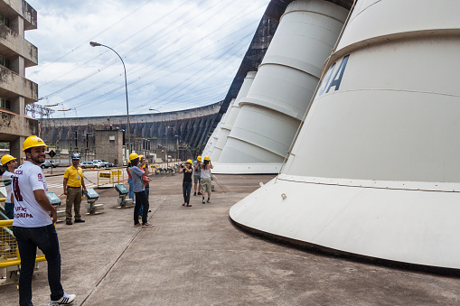 ITAIPU, BRAZIL/PARAGUAY - FEB 4, 2015: Tourists visit Itaipu dam on river Parana on the border of Brazil and Paraguay