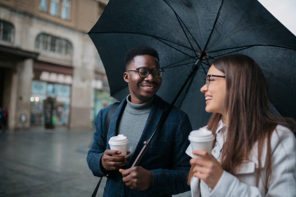 istock Happy diverse couple walking on a rainy day 1311352756