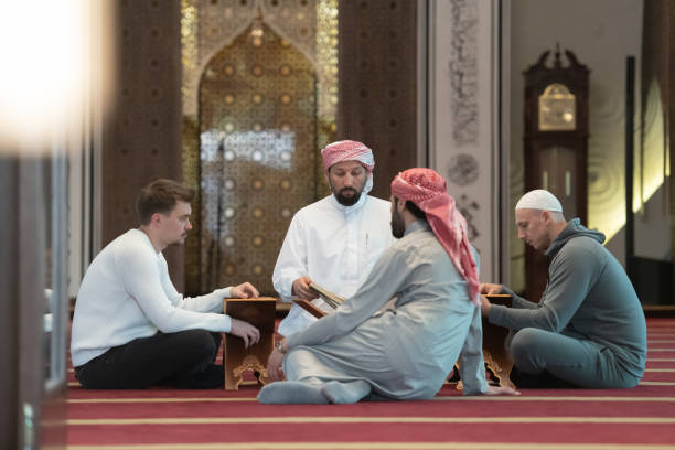 istock muslim people in mosque reading quran together 1311353356