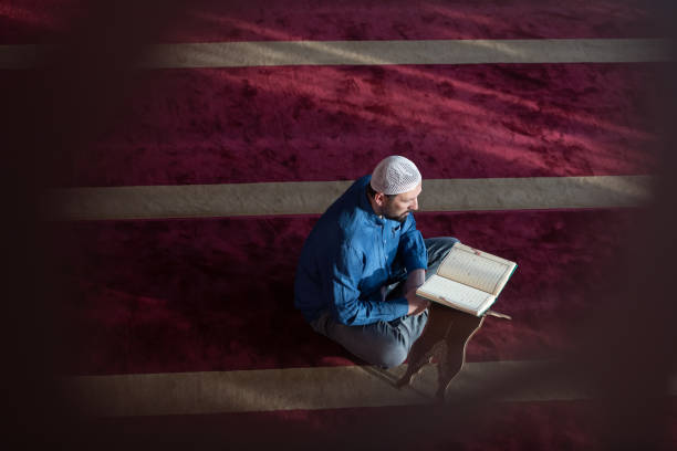 istock muslim man praying Allah alone inside the mosque and reading islamic holly book 1311353477