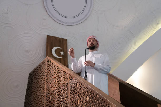 istock Muslims young arabic Imam has a speech on friday afternoon prayer in mosque. 1311354991