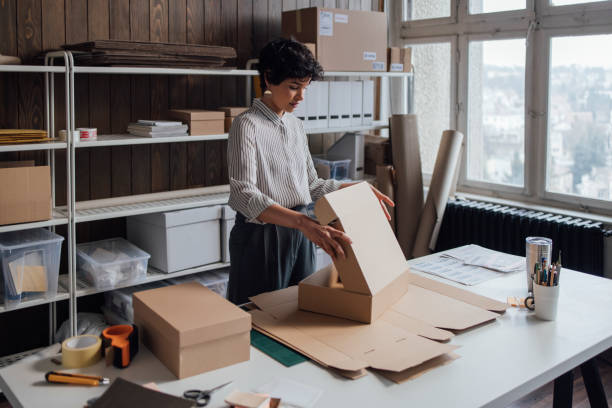 istock Young Online Store Owner Making Boxes to Ship Her Products 1311355127