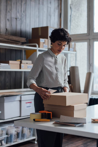 istock Small Business Owner Preparing Packages for Delivery 1311355176