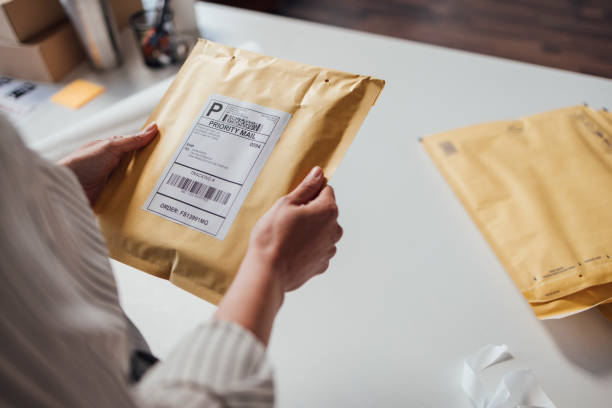 istock Anonymous Online Shop Owner Holding an Envelope before Shipping It 1311355230