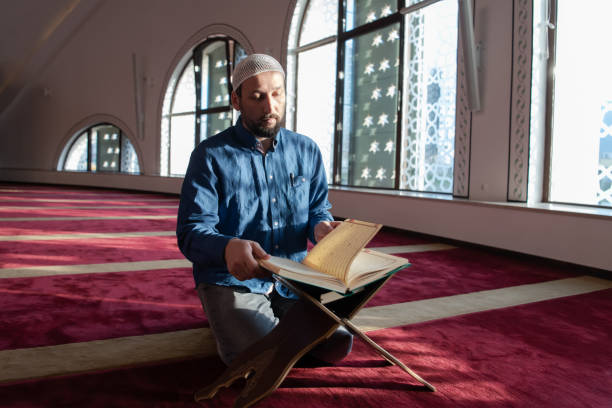 istock muslim man praying Allah alone inside the mosque and reading islamic holly book 1311356967