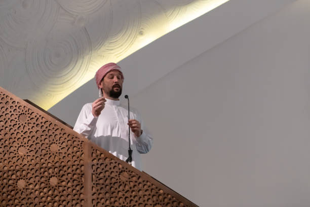 istock Muslims young arabic Imam has a speech on friday afternoon prayer in mosque. 1311357603